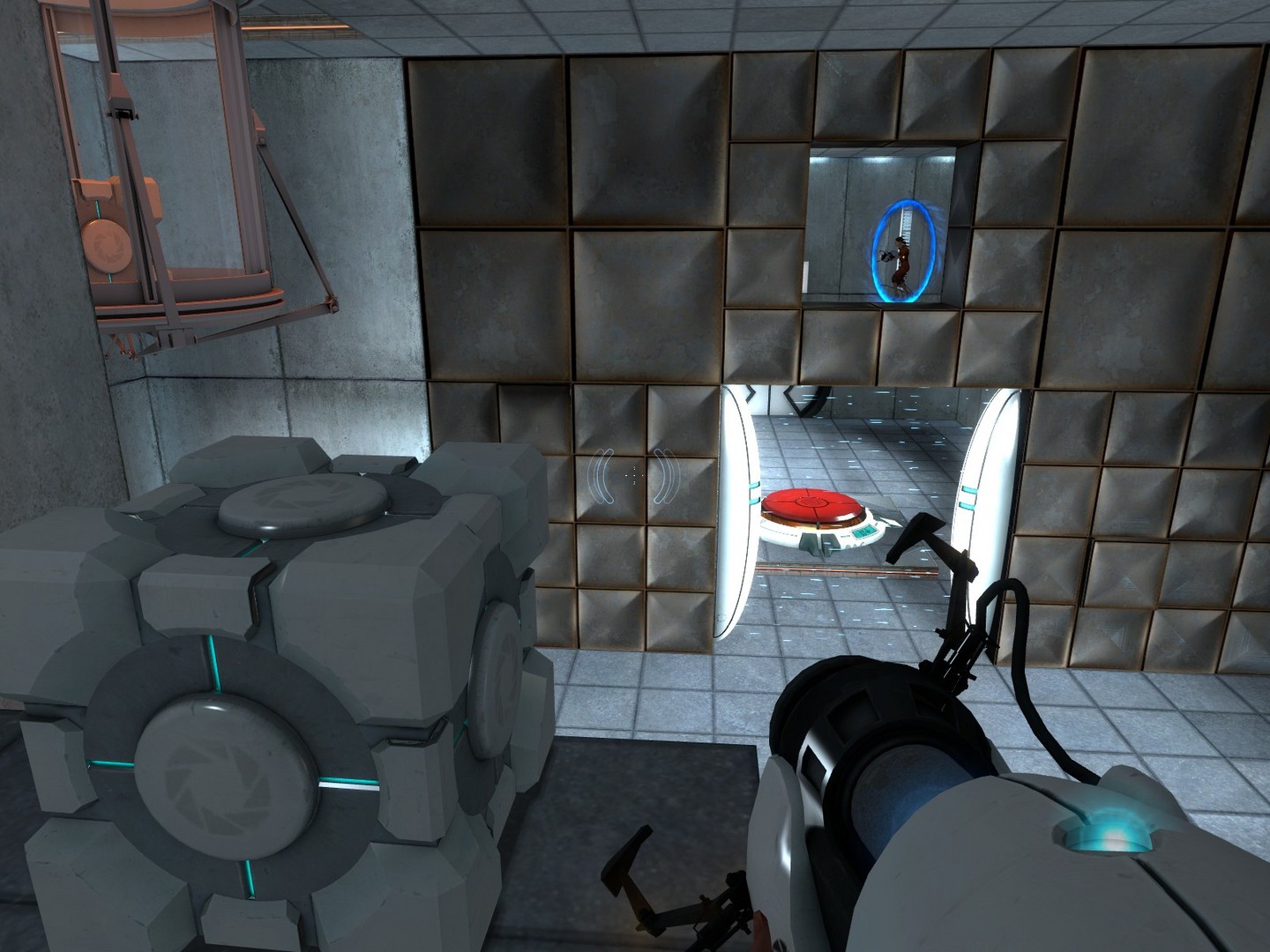 First-person view inside a Portal test chamber with the portal gun visible and an orange portal on the wall